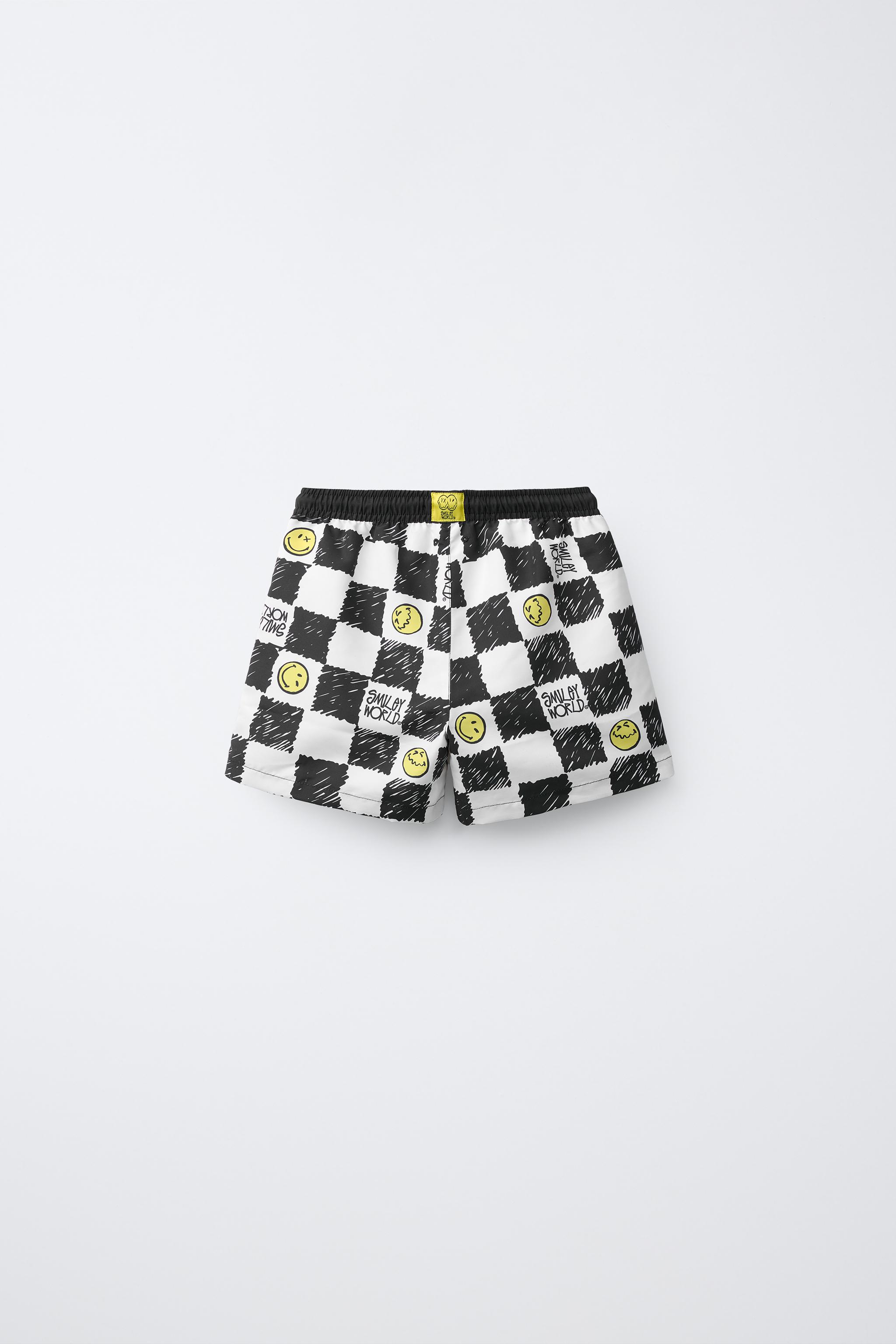 6-14 ANS/ SHORT DE BAIN DAMIER SMILEYWORLD ®